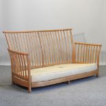 An Ercol light elm three seater sofa,