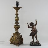 A bronzed model of a cherub, together with a gilt lamp base,