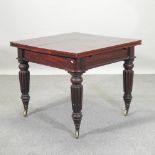 A Victorian mahogany draw leaf dining table, on reeded legs,