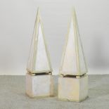 A pair of white painted wooden obelisks,