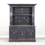 A 19th century dark oak dresser, relief carved with portrait medallions,