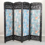 A Chinese carved hardwood four fold dressing screen,