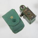 A 1930's Coronet Midget green bakelite cased miniature camera,
