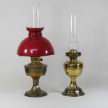A brass oil lamp, with a glass shade, 60cm high,