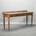 A rustic hand made pine serving table, on turned legs,