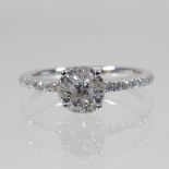 An Emson Haig diamond cluster ring, with diamond set shoulders, approximately 0.