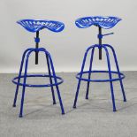 A blue painted tractor seat stool,