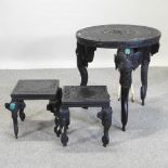 An Indian hardwood occasional table, on elephant supports, 61cm diameter,