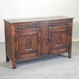 An oak sideboard, with linen fold decoration,