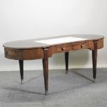 An Art Deco style mahogany desk, with an inset writing surface,
