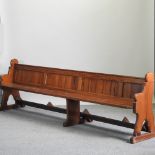An early 20th century pine pew,