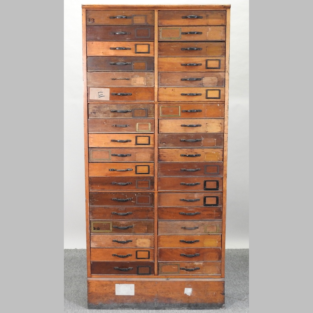 An early 20th century bank of drawers, containing two rows of eighteen drawers,