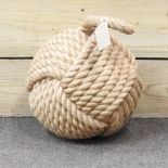 A woven rope door stop,