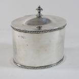 An Edwardian silver tea caddy, of oval shape, with a hinged lid, London 1907,