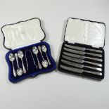 A set of silver tea spoons, cased, together with a set of silver fruit knives,