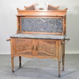 An Edwardian satin walnut marble top wash stand,