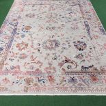 A large Indian woollen carpet, with floral designs, on a grey ground,