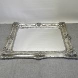 A large silver painted wall mirror,
