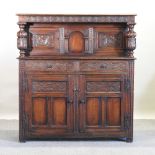 A 17th century style carved oak court cupboard,