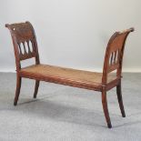 A Regency style oak window seat, with a cane seat,