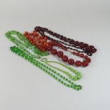 A cherry amber bakelite bead necklace, 72cm drop, together with another smaller,