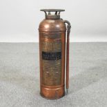 A vintage copper fire extinguisher,