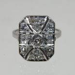 A platinum and diamond Art Deco style cluster ring, set with a central collet set diamond,