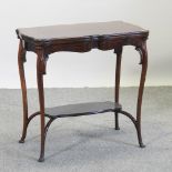 An Edwardian mahogany folding card table, on cabriole legs,