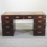 A campaign style mahogany twin pedestal desk,