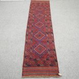 A Turkish woollen runner, with five central diamonds, on a blue ground,