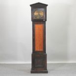 An early 20th century oak cased electric longcase clock,