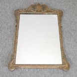 A 19th century painted and gilt framed shaped wall mirror,