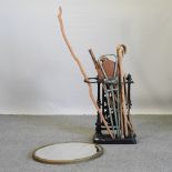 A Victorian cast iron stick stand, 73cm high, together with a collection of walking sticks,