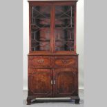 A George III mahogany secretaire bookcase, with a fitted interior and base fitted with slides,