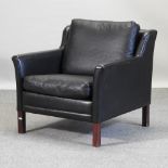 A mid 20th century black upholstered Danish armchair