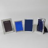 A collection of four modern silver photograph frames,