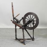 A 19th century oak spinning wheel,