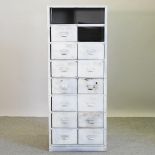 A white painted metal chest of short drawers,