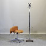 A mid 20th century orange upholstered desk chair, together with a chrome hatstand,