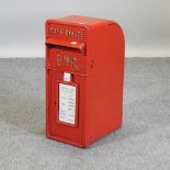 A reproduction red painted post box,