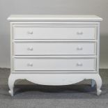 A white painted French style chest of drawers,