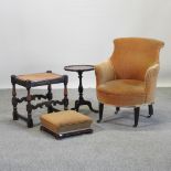 An Edwardian beige upholstered tub shaped armchair, together with a wine table,