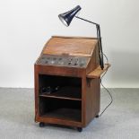 A mid 20th century optician's lens cabinet, with a tambour top,