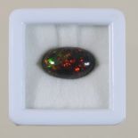 An unmounted black opal cabochon, 3.