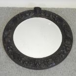 A 19th century carved oak circular wall mirror,