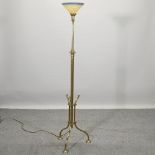 A brass standard lamp with a glass shade,