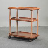 An Ercol light elm drinks trolley,