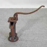 A rusted metal garden pump,