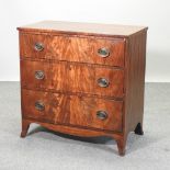 A Regency mahogany and ebony strung chest, containing three long drawers,