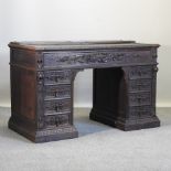 A 19th century heavily carved oak pedestal desk,